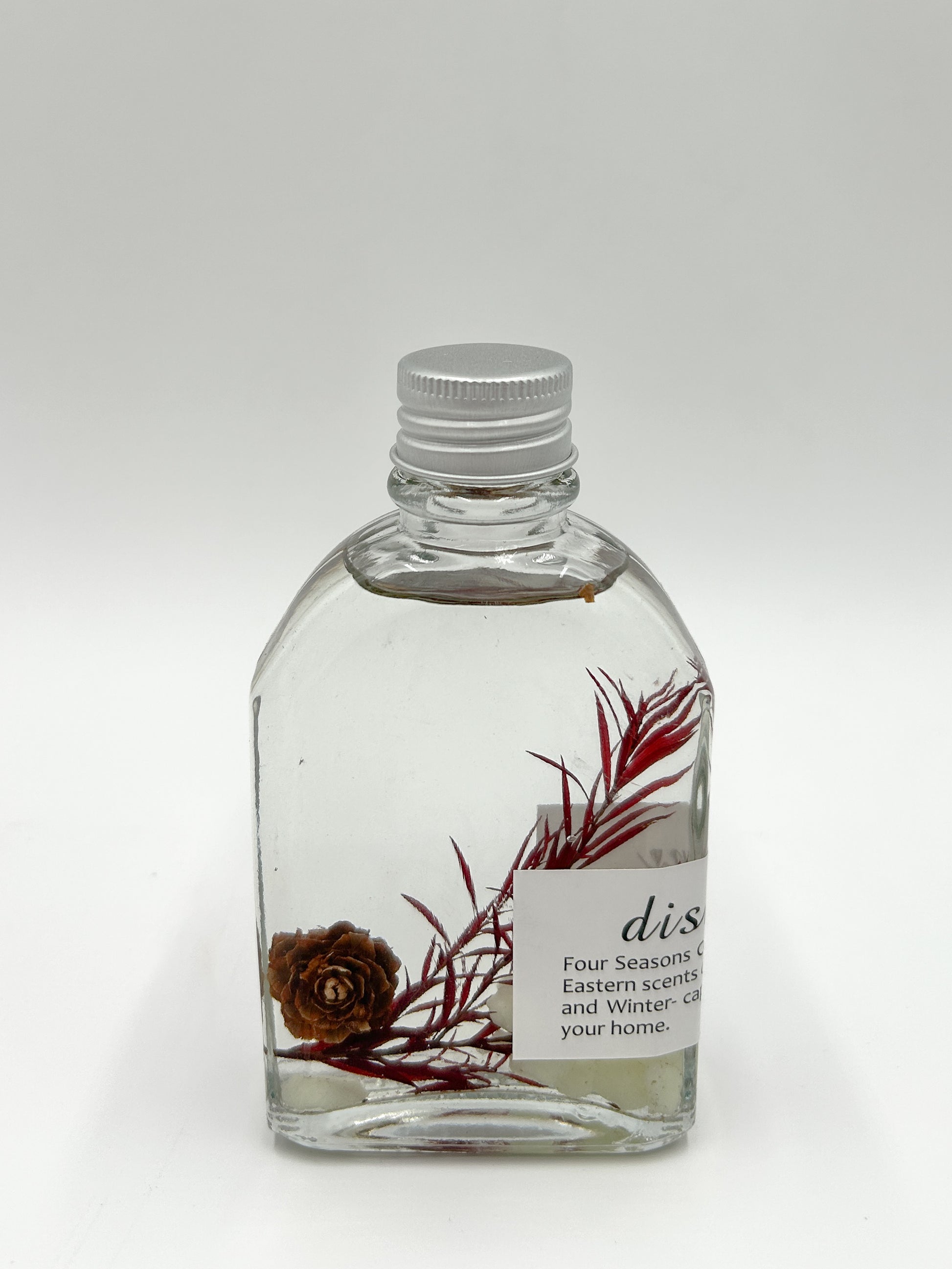 Floral scented reed diffuser with dried flowers.