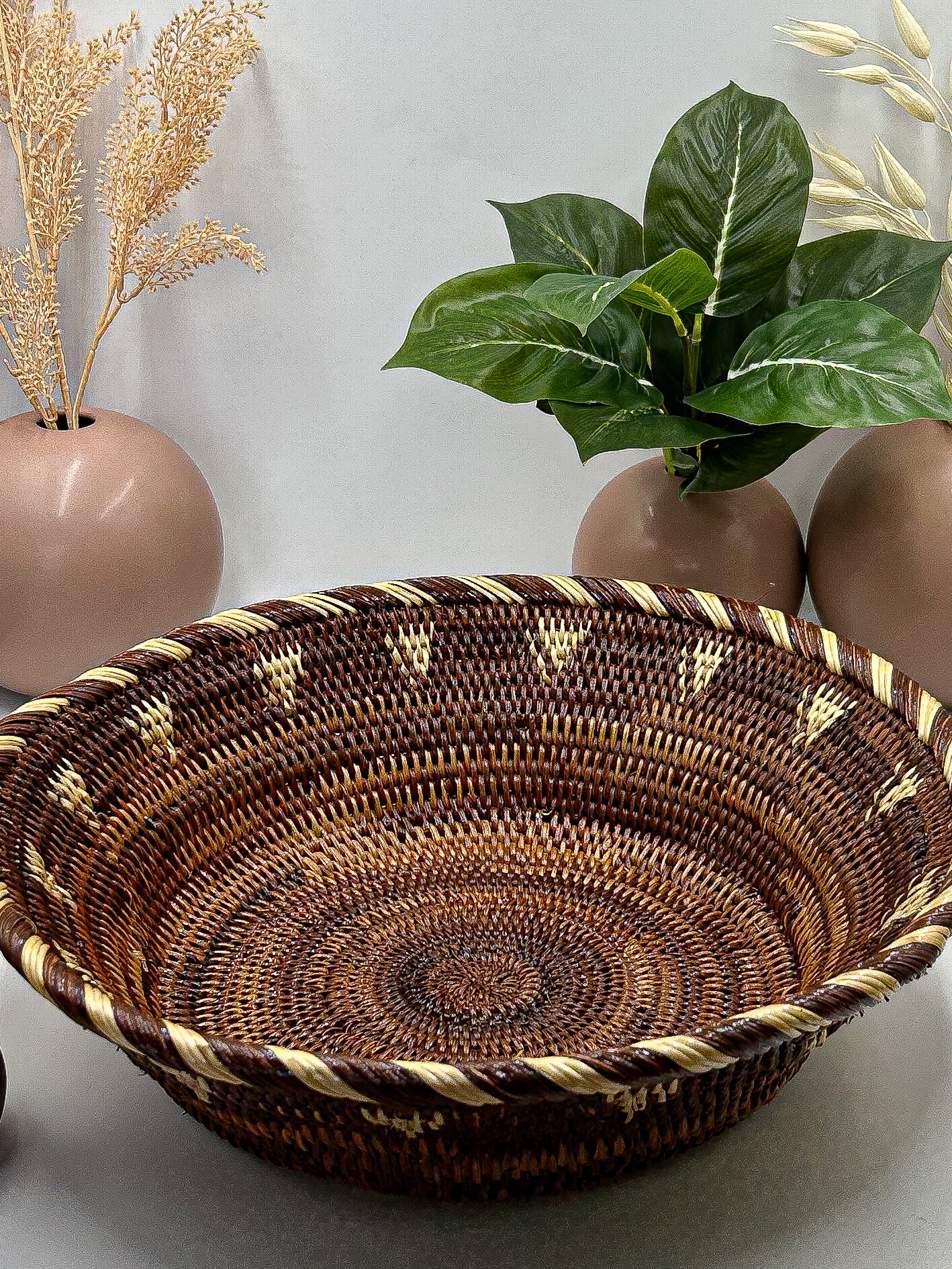 Brown & Cream Round Handwoven Basket from Papua New Guinea without handles with triangle and stripe detailing.