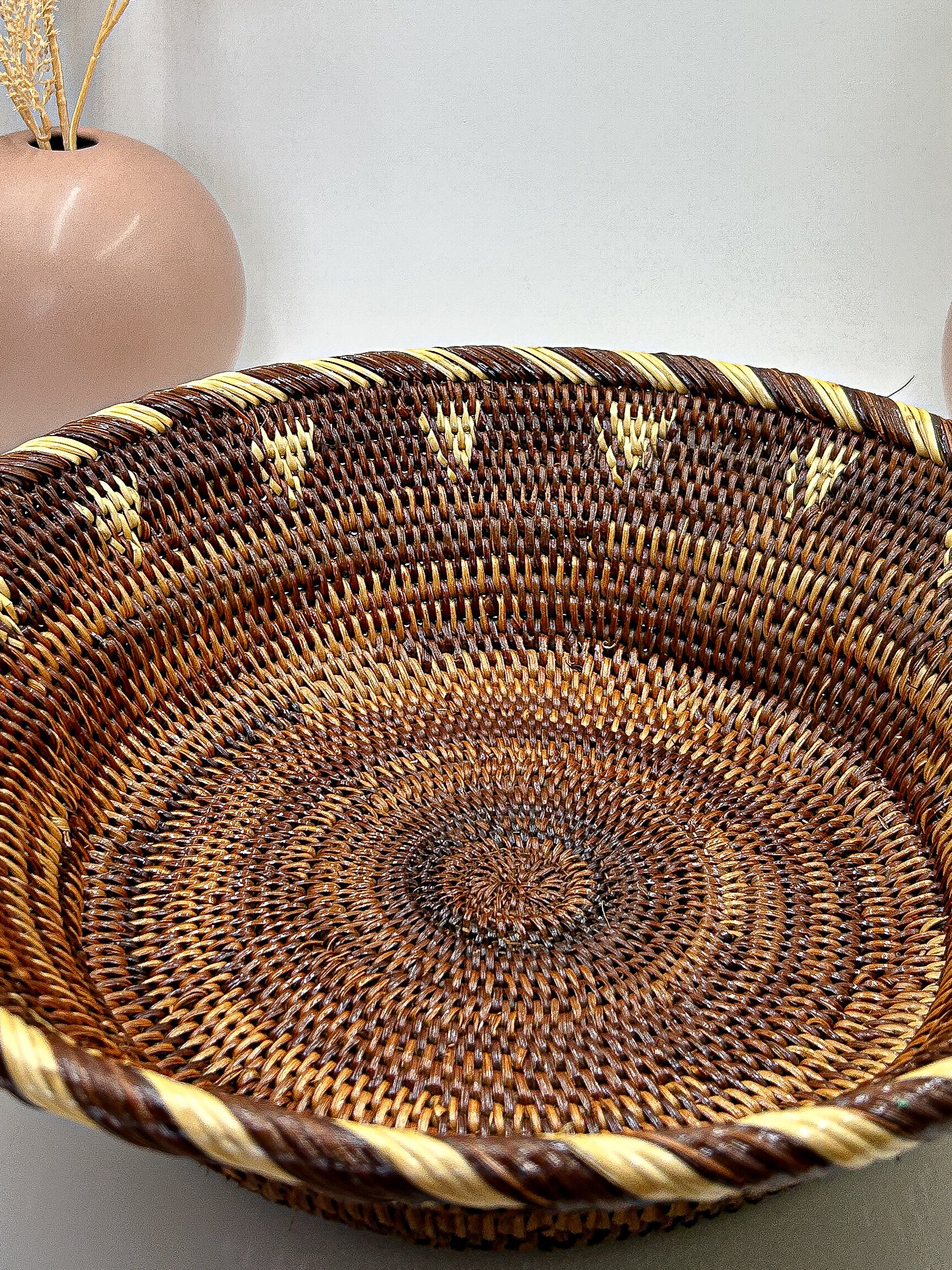 Brown & Cream Round Handwoven Basket from Papua New Guinea without handles with triangle and stripe detailing.