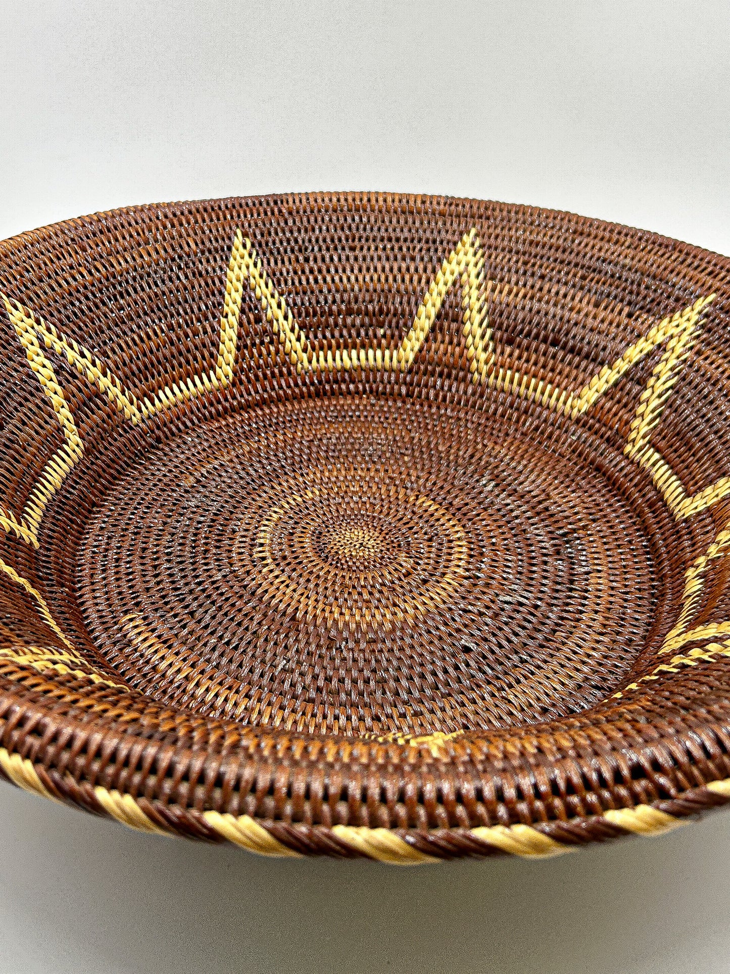 Brown & Cream Round Handwoven Basket from Papua New Guinea without handles with star detailing.