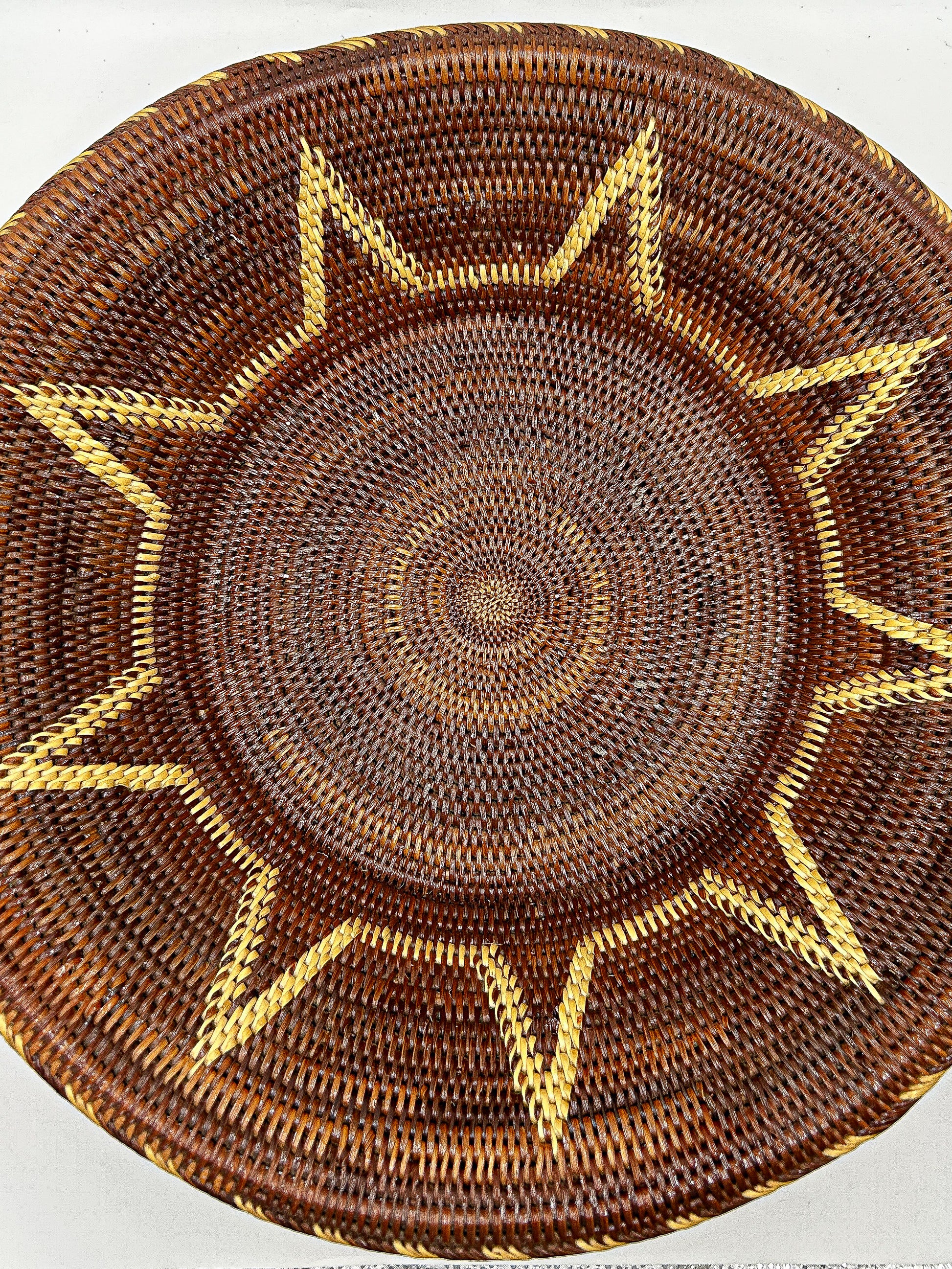 Brown & Cream Round Handwoven Basket from Papua New Guinea without handles with star detailing.