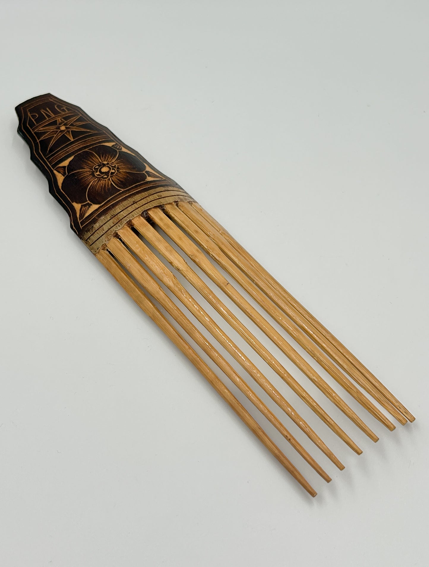 handcarved decorative hair comb from Papua New Guinea with Hibuscus Flower