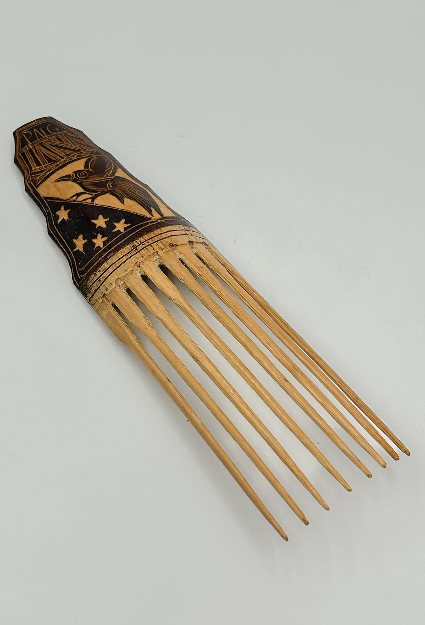 handcarved decorative hair comb from Papua New Guinea with Papua New Guinea Flag